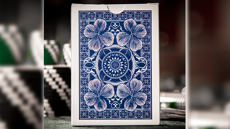 Blue floral-patterned card deck packaging on a blurred background