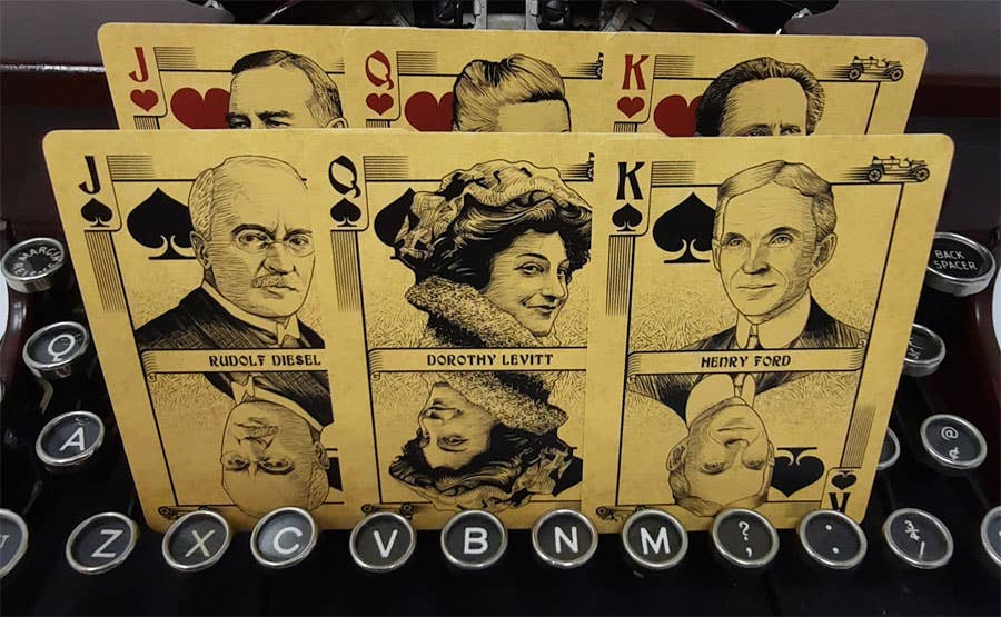 Playing cards with vintage portraits on a typewriter keyboard