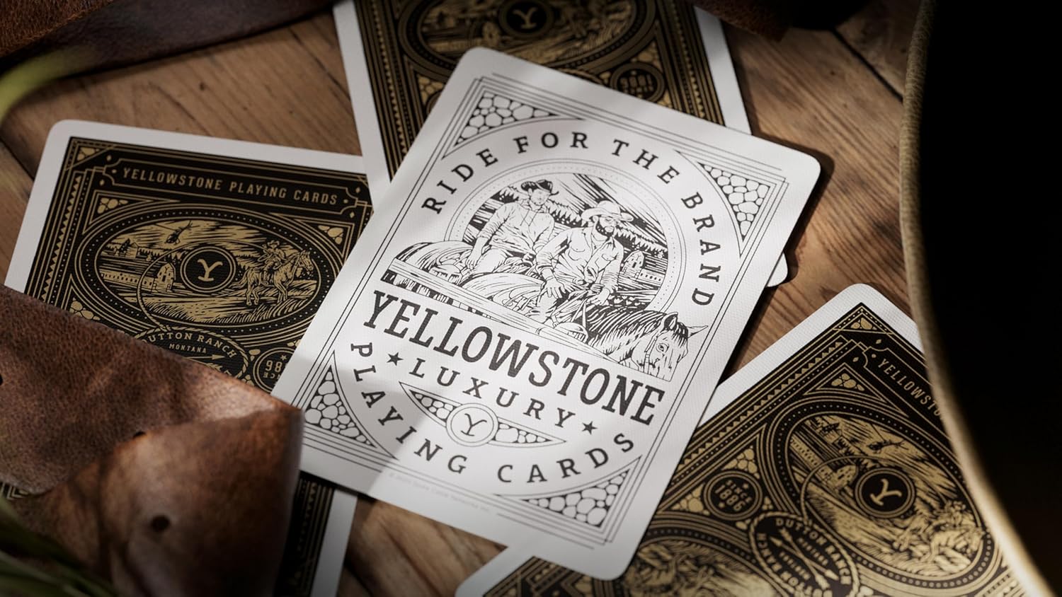 Yellowstone luxury playing cards on a wooden surface with a dog in the background