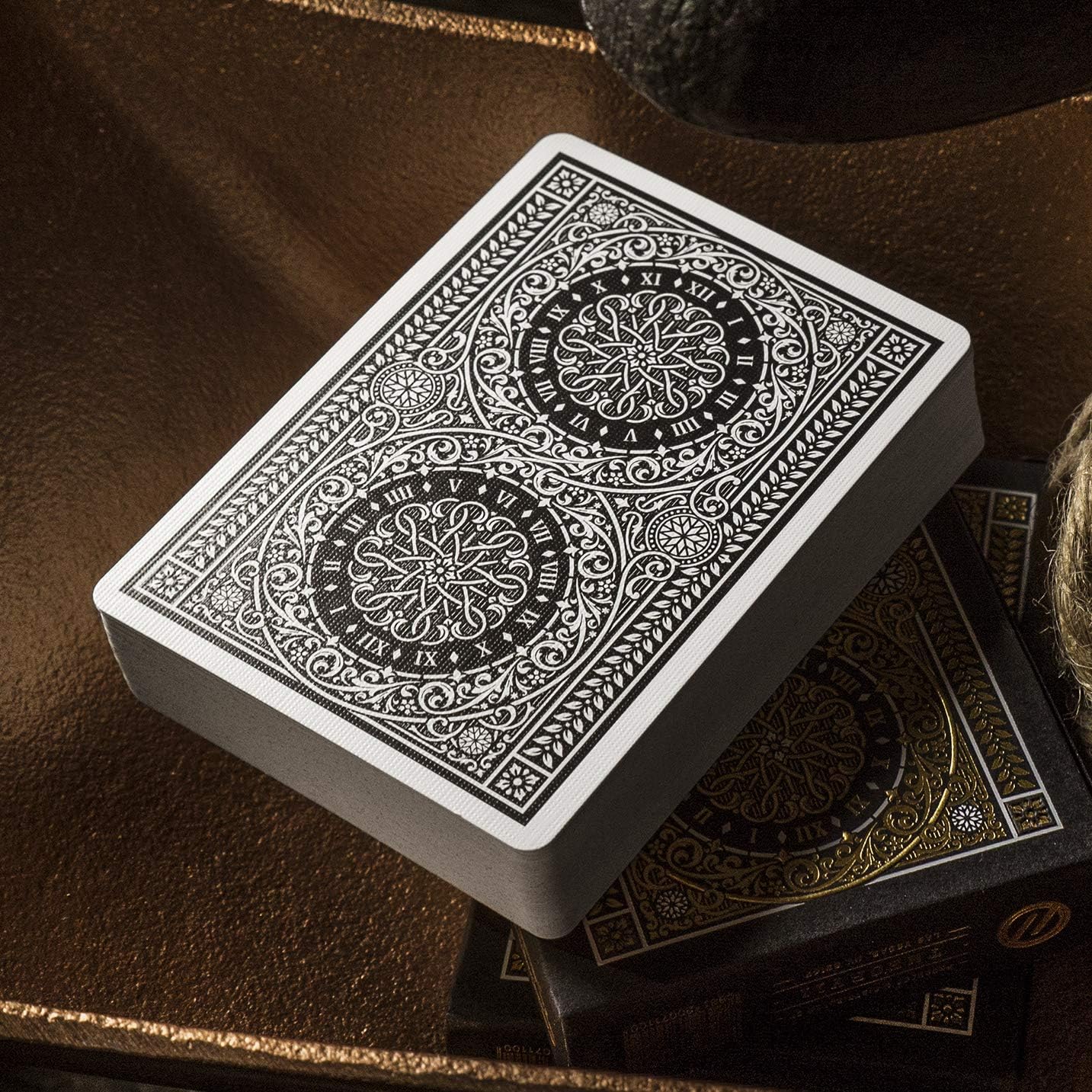 Decorative deck of cards with intricate designs on a brown surface