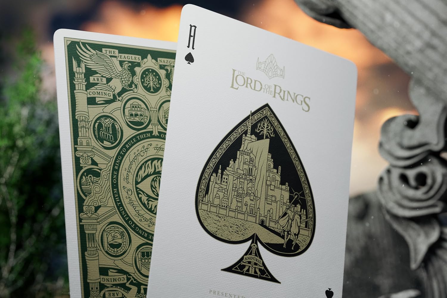 Two playing cards from 'The Lord of the Rings' series with detailed artwork on a blurred background.