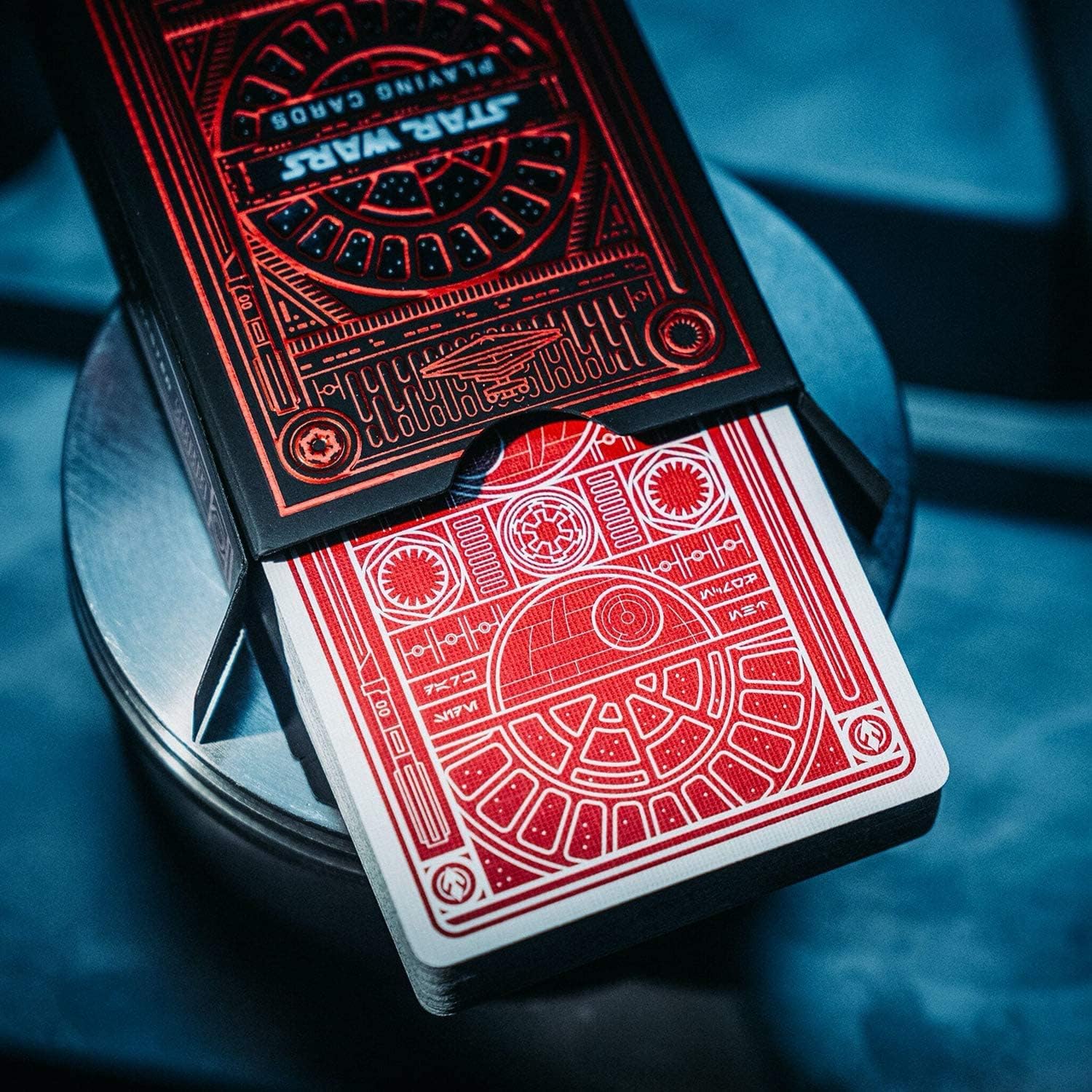 Star Wars-themed playing cards with red and black design on a metallic stand.