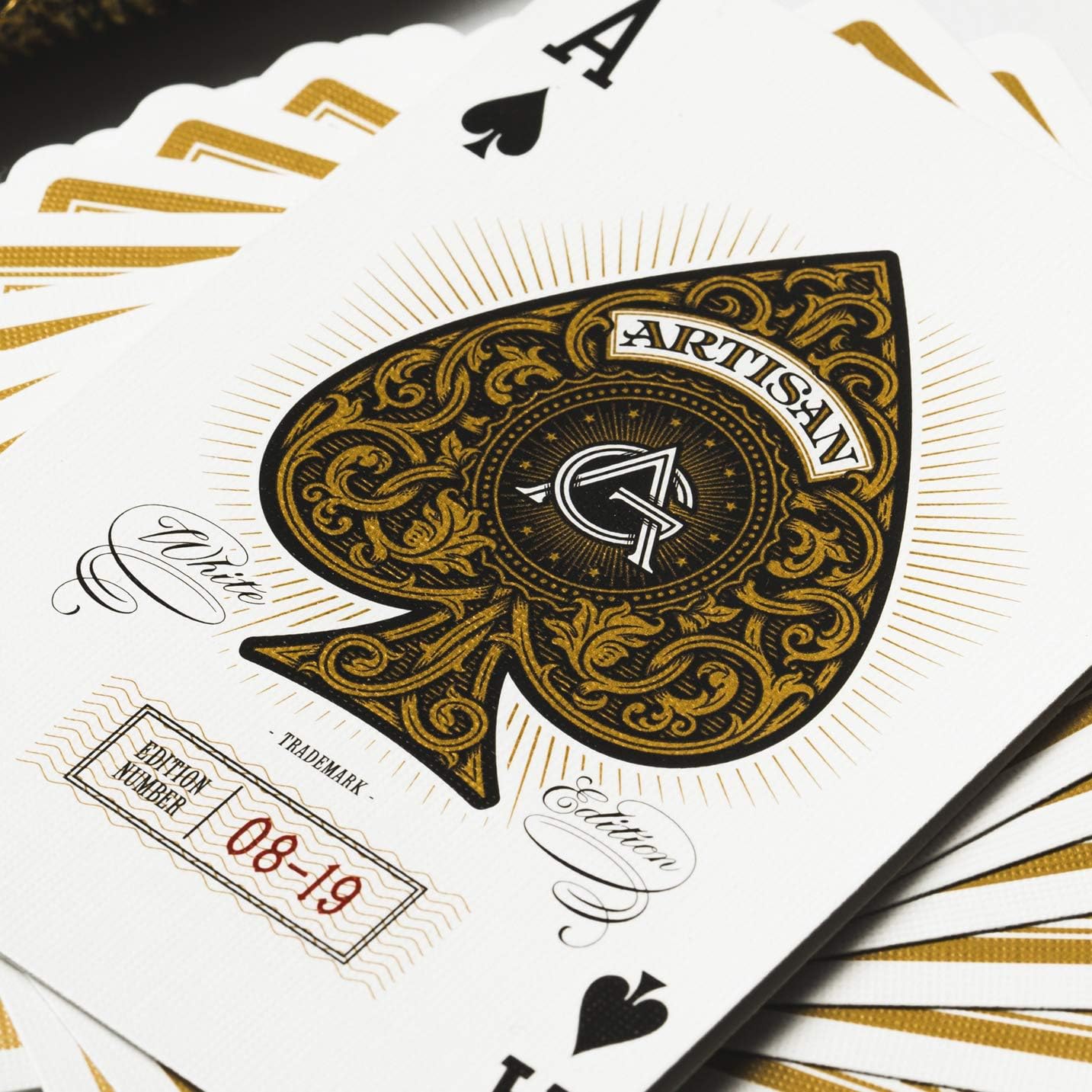 Playing cards with 'Artisan' branding on a white background