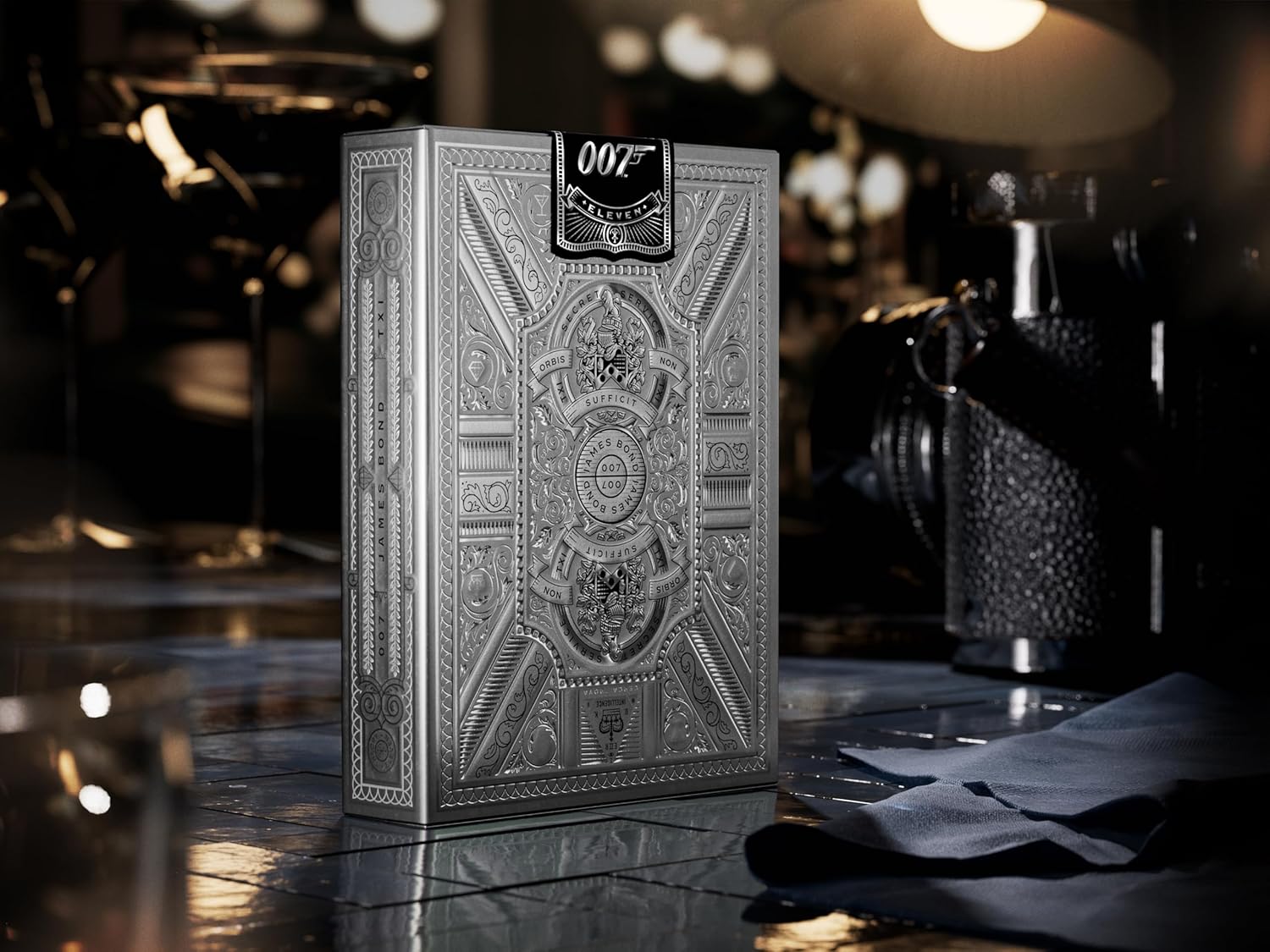 Decorative box with intricate design and '007' branding on a reflective surface.