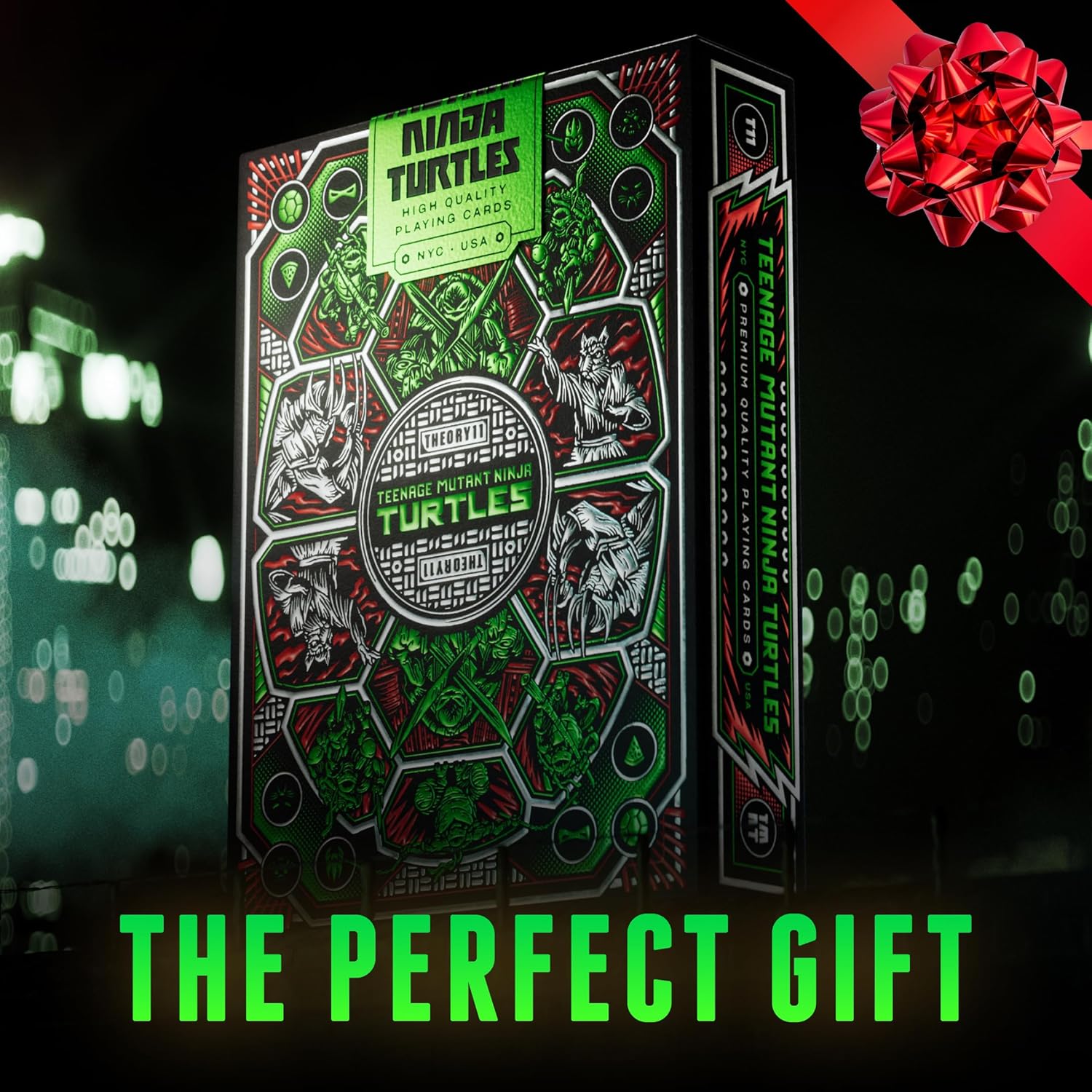 Teenage Mutant Ninja Turtles playing card box with a red bow, labeled 'The Perfect Gift', on a dark background.