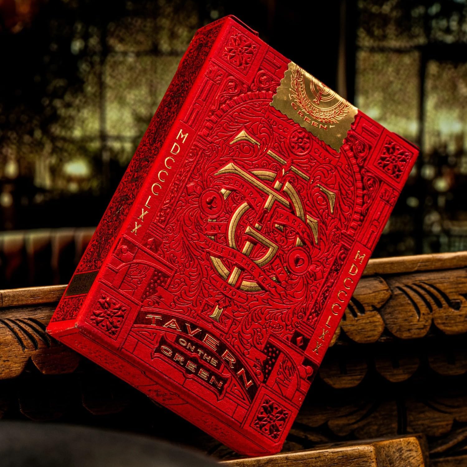 Close-up of red Tavern on the Green theory11 tuck box with gold embossing