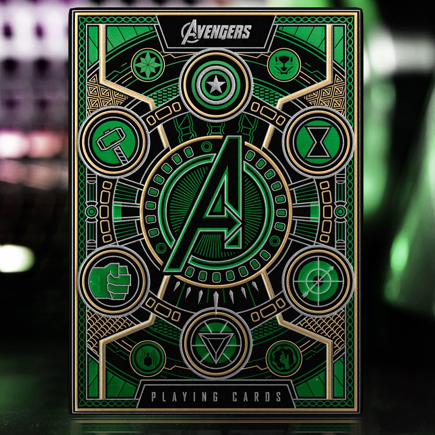 Avengers playing cards with green and gold design on a dark background