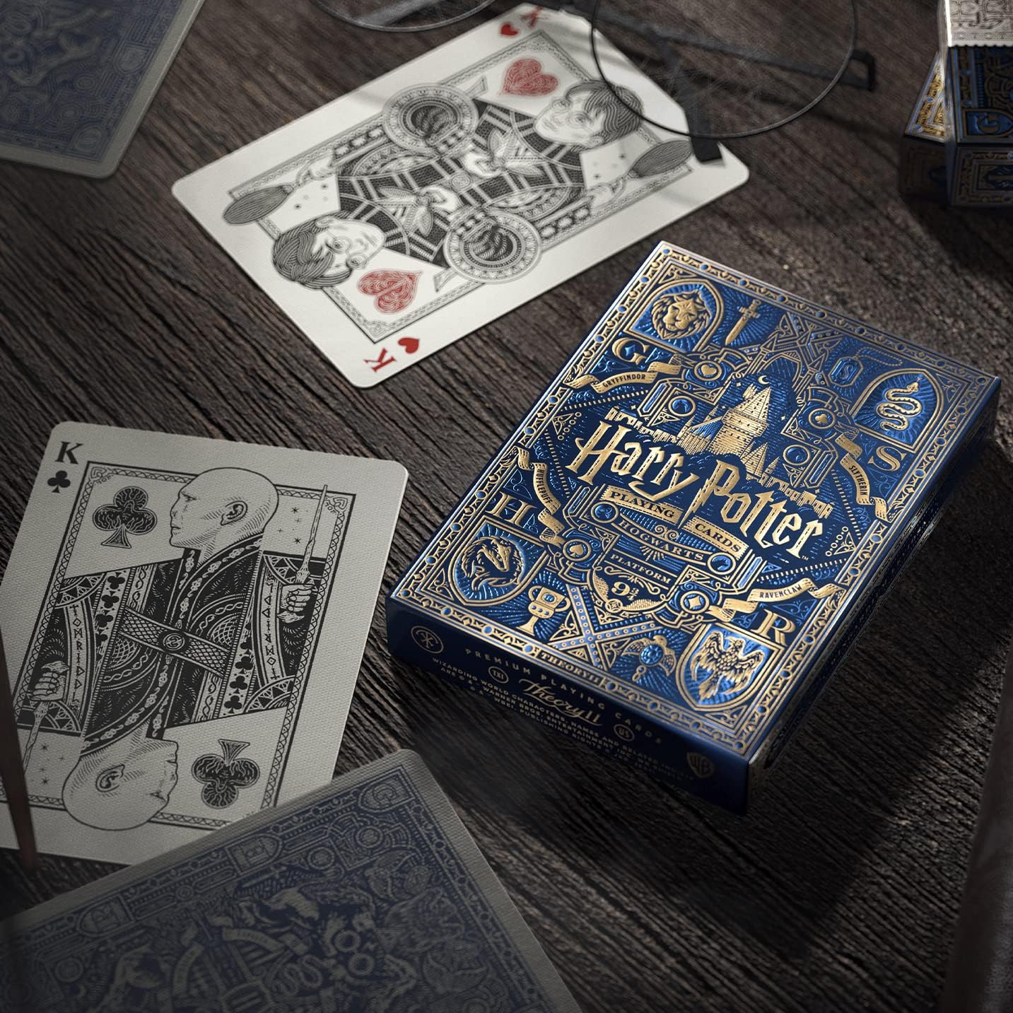 Harry Potter themed playing cards on a wooden surface with cards fanned out.