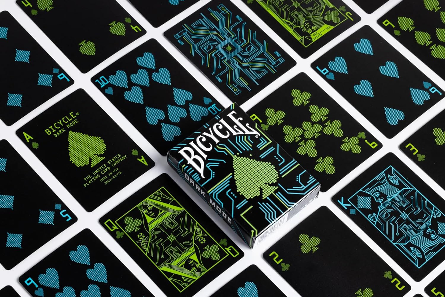 Bicycle Dark Mode playing cards spread with black faces and blue green accents