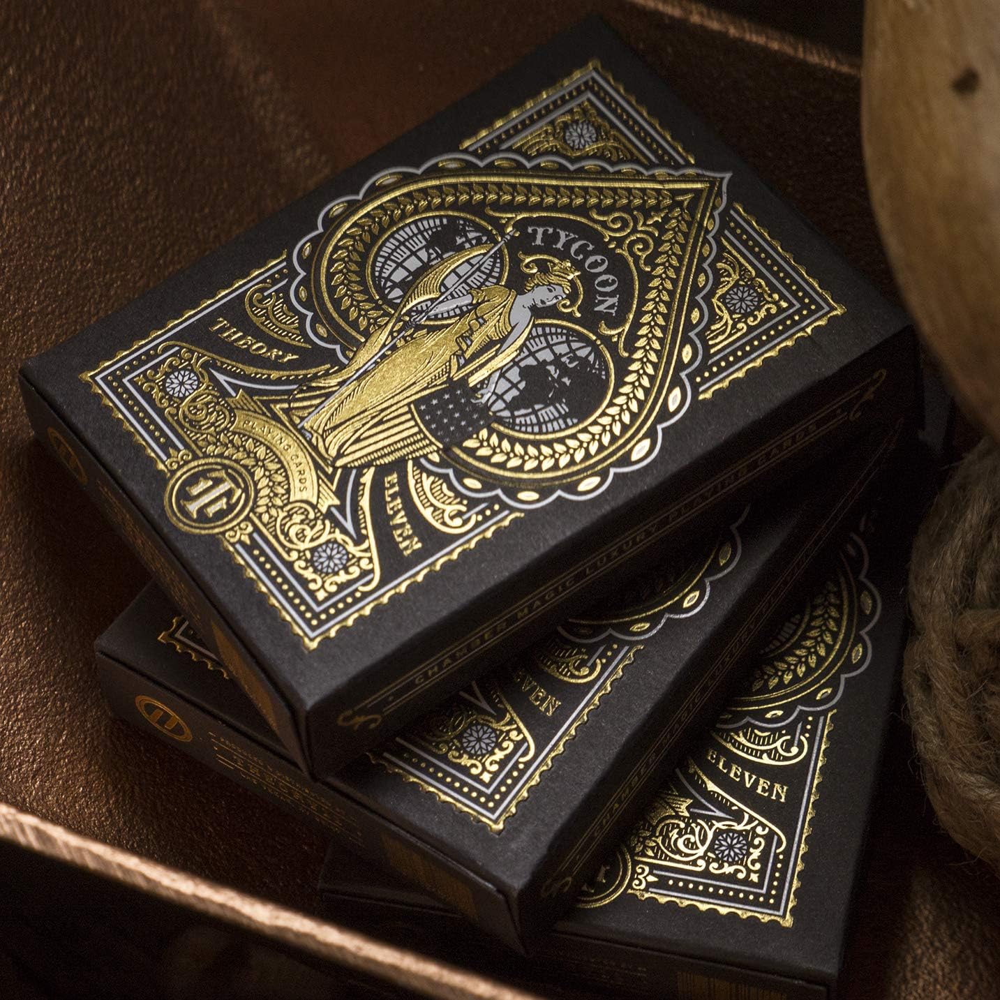 Decorative black and gold card boxes stacked on a wooden surface