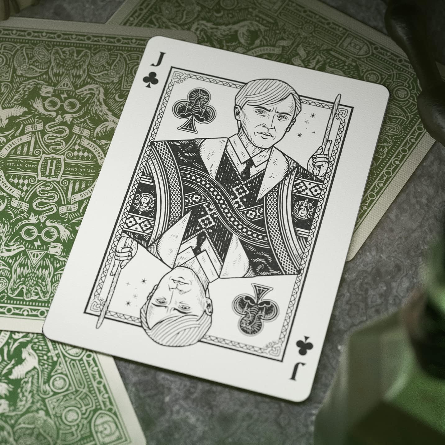 Playing card with a character design on a green patterned surface