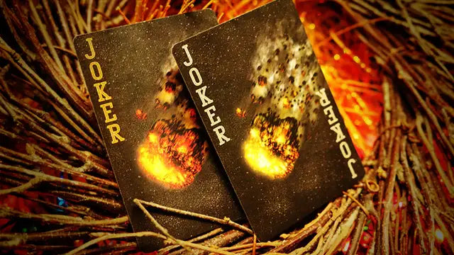 Two joker cards with fiery designs on a rustic background
