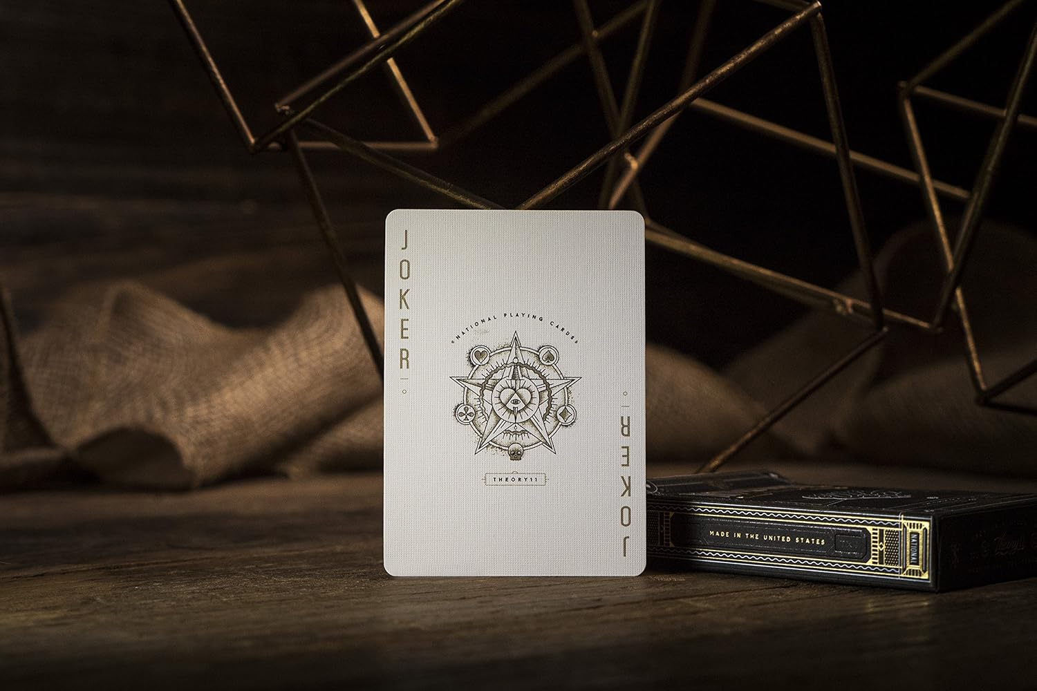 Joker card from a deck with intricate design on a wooden surface.