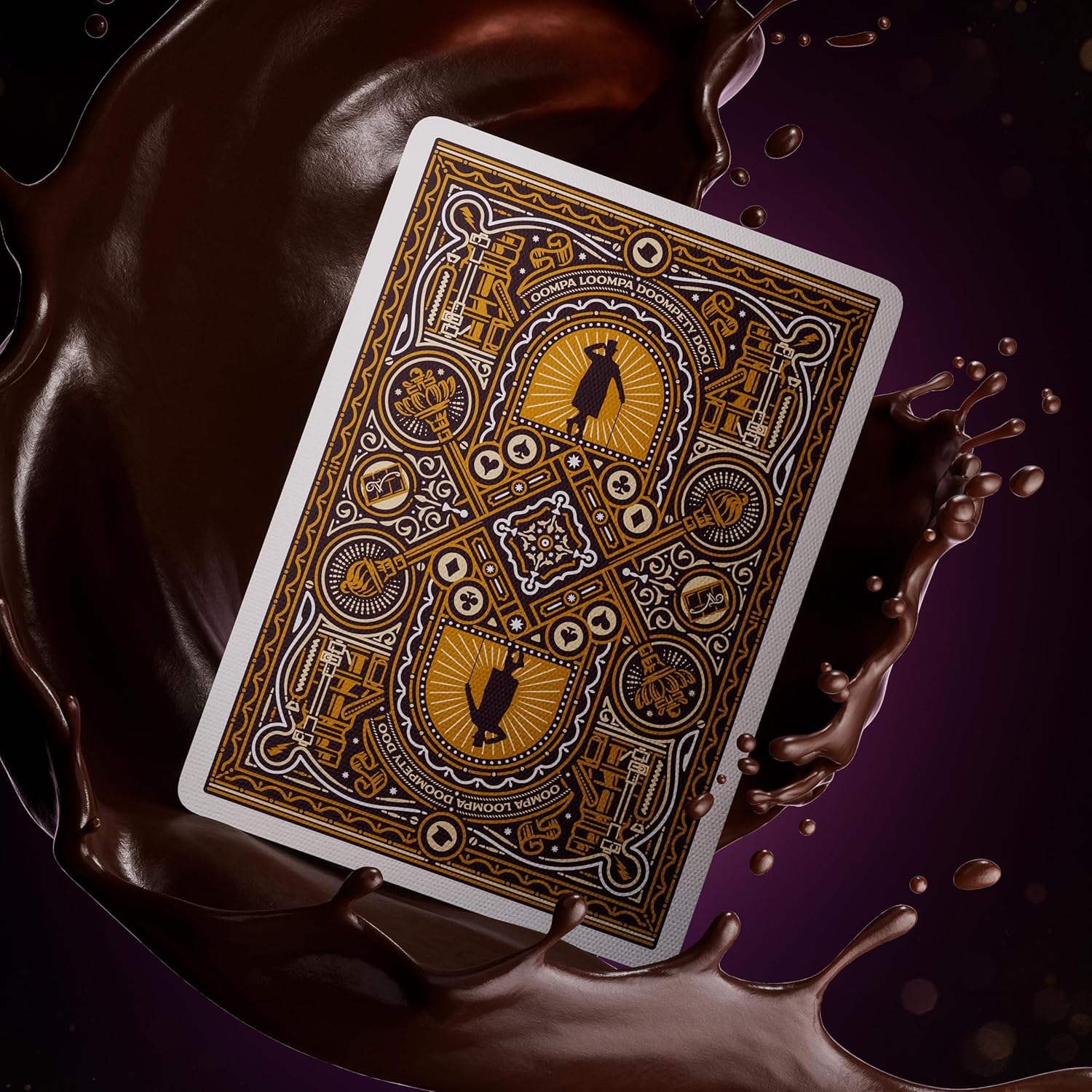 Decorative playing card with intricate designs on a dark background with chocolate-like liquid.