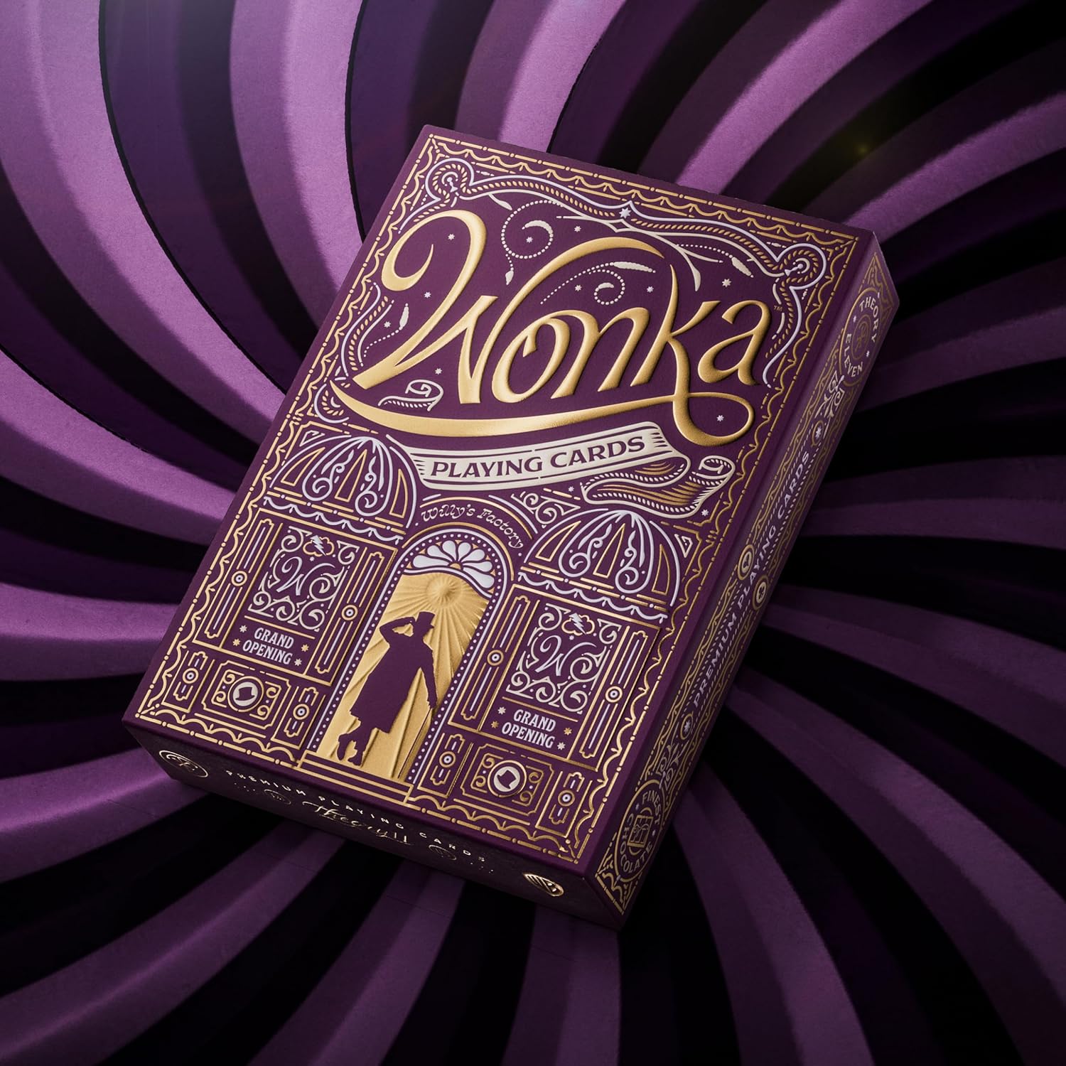 Wonka playing cards box with intricate design on a purple spiral background