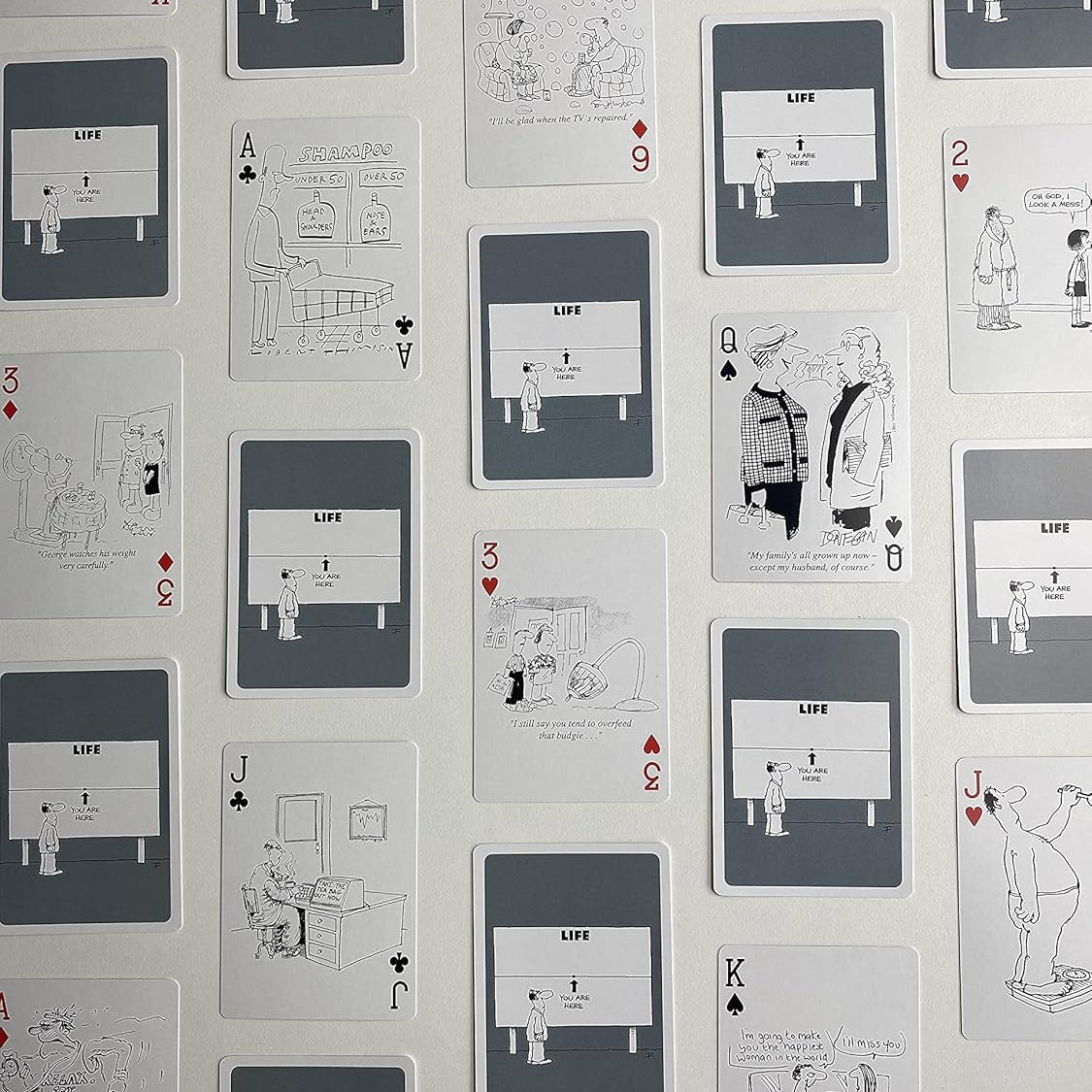 Piatnik Senior Moments deck showing black-and-white cartoons and custom gray card backs