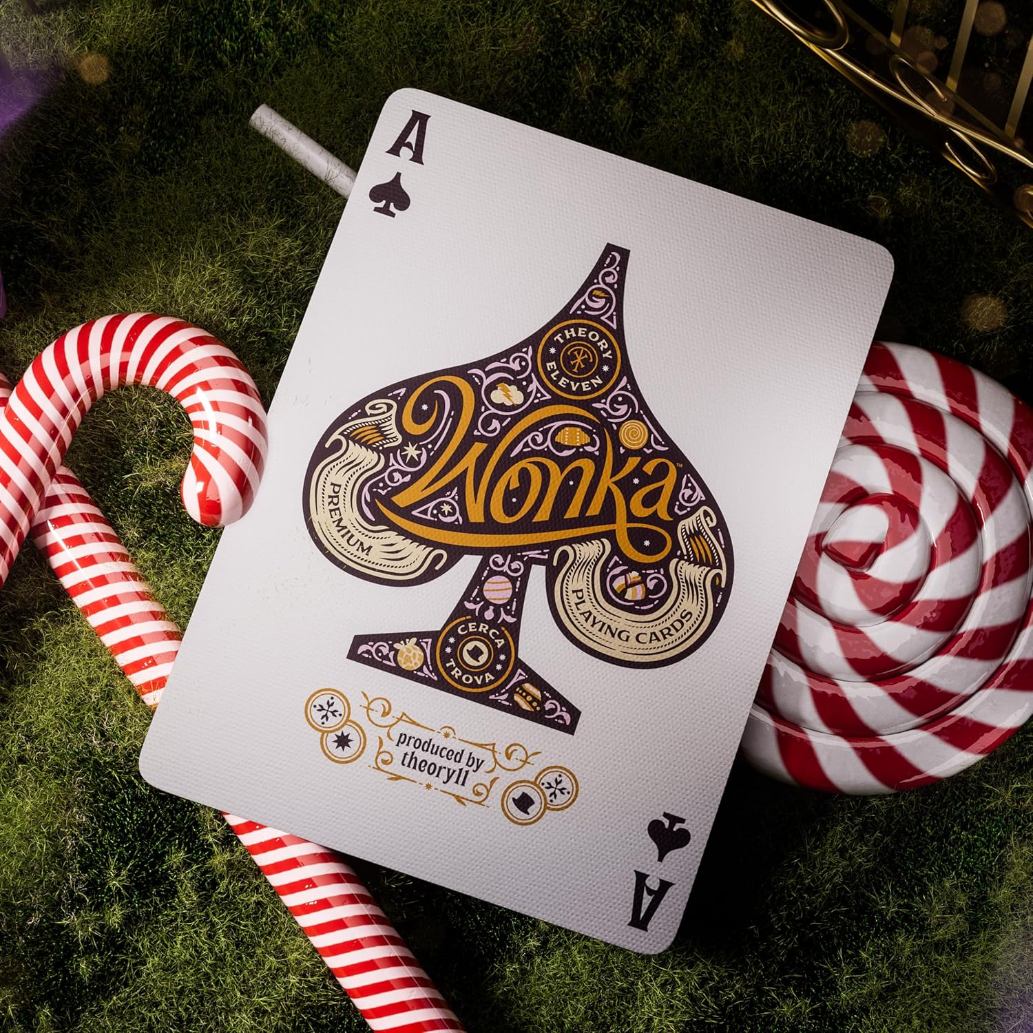 Playing card with 'Wonka' branding on a green surface with candy canes and lollipop.