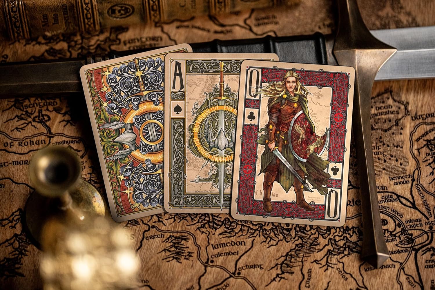 Spread of Return of the King back design, Ace of spades, and Éowyn queen of clubs card on a Middle‑earth map.
