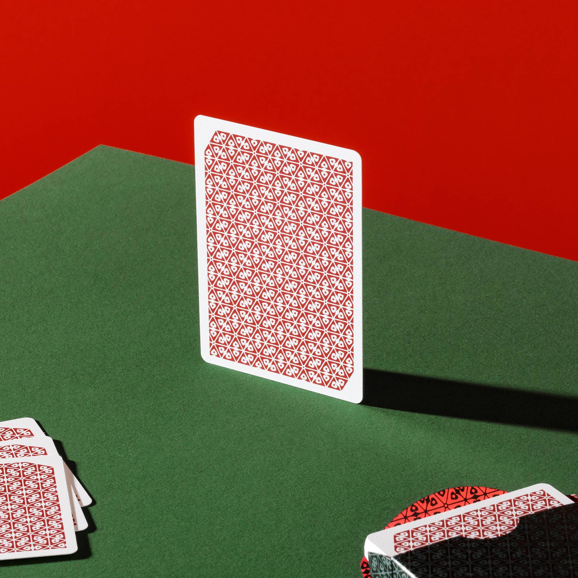 Vanda Aces Red Playing cards on a green surface with a red background