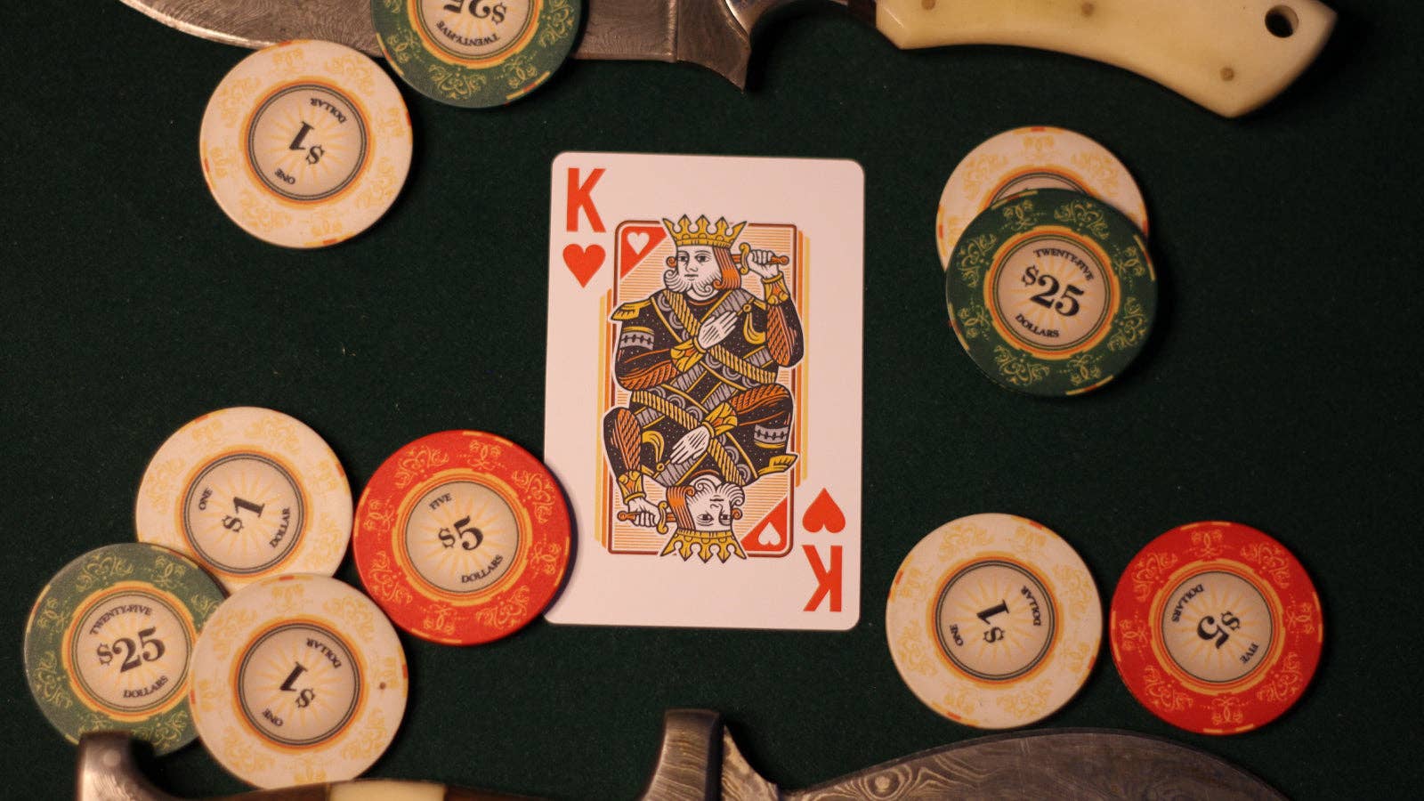 Poker king card with poker chips on a dark surface