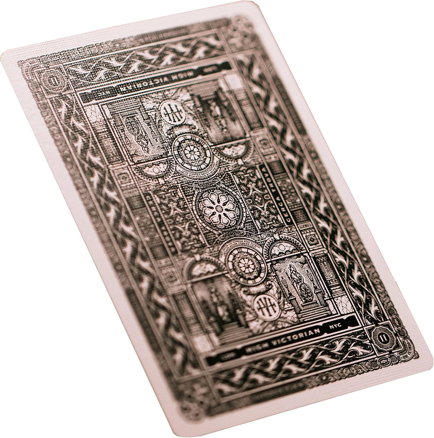 Decorative playing card with intricate black designs on a white background