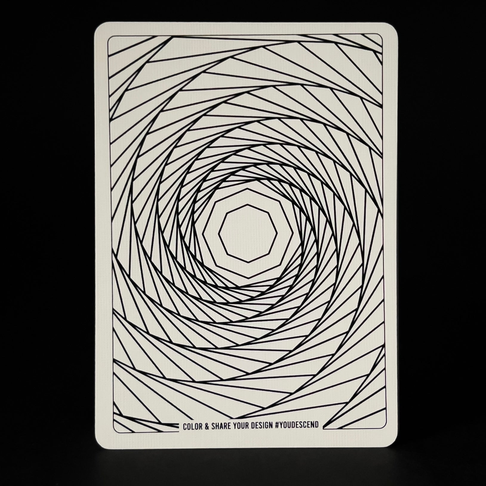 Card with a geometric spiral design on a black background