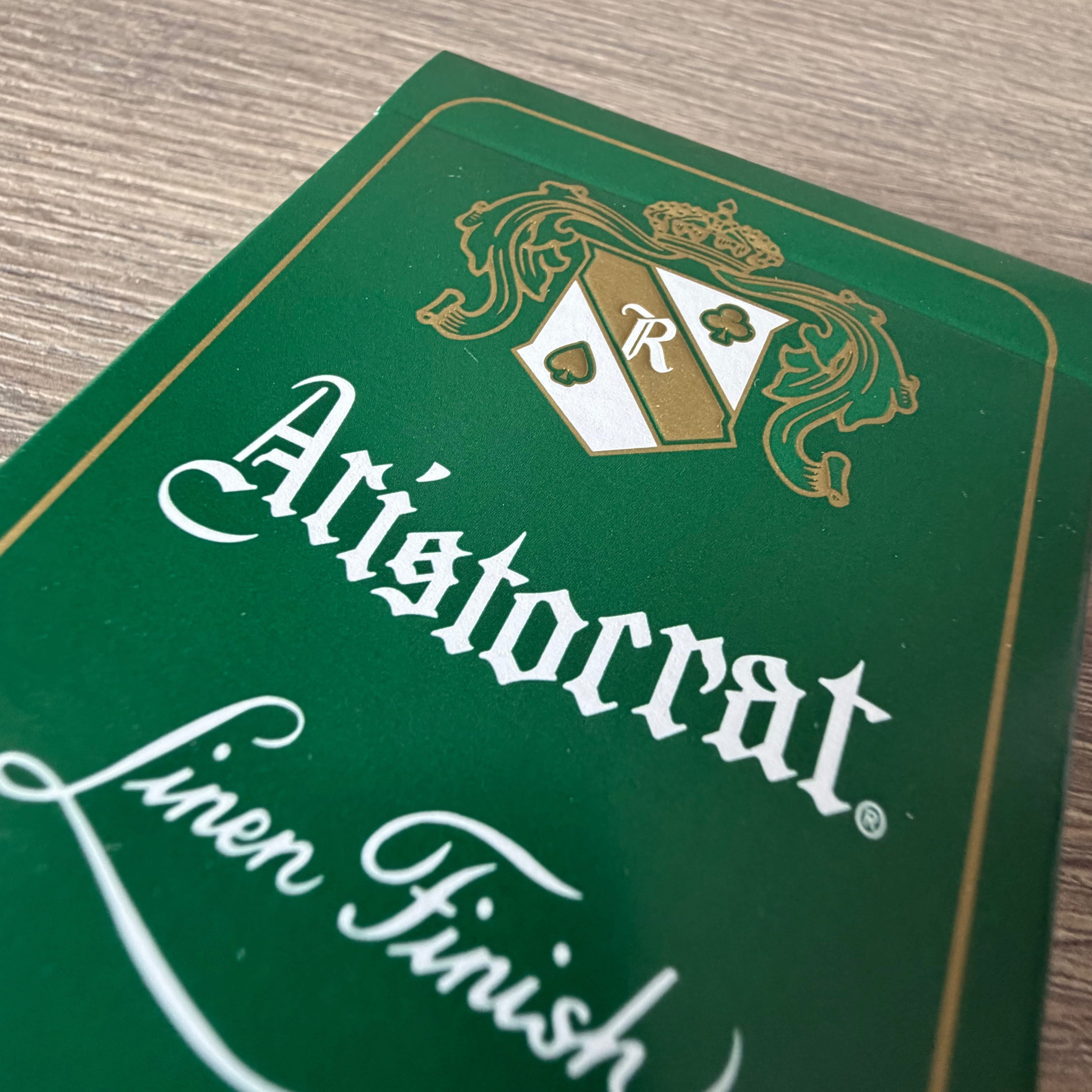 Close-up of Aristocrat 727 Currency Green linen finish embossing on playing card surface