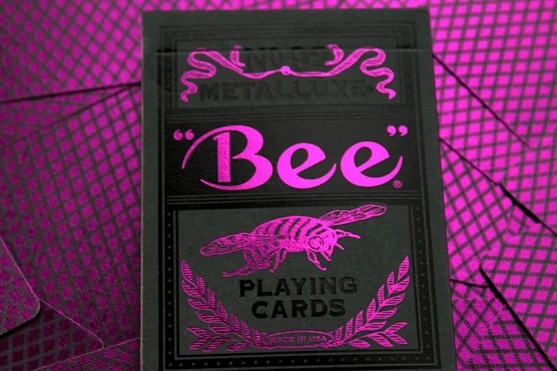 Bee Magenta & Black Metalluxe playing card deck with pink 'Bee' branding on a magenta checkered background