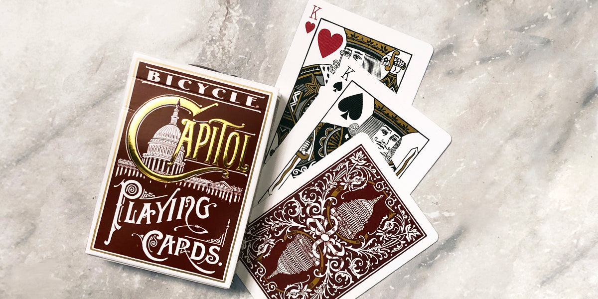 Bicycle Capital playing cards on a textured surface