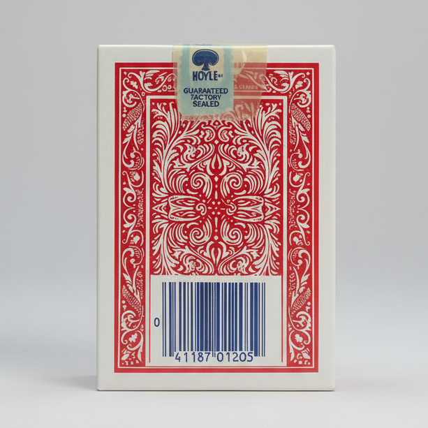 Red and white playing card box with a bar code and 'Hoyle' brand tag on a wooden surface.