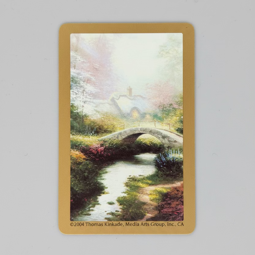Thomas Kinkade garden cottage and stone bridge artwork on 2004 Congress Gardens playing card back
