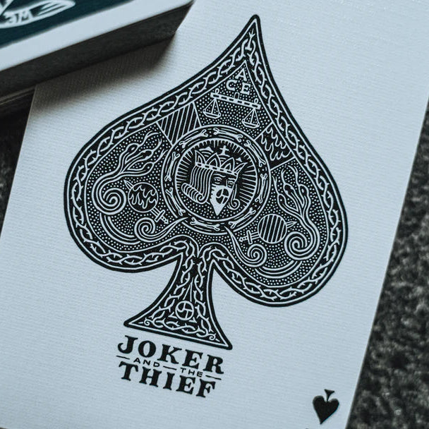 Joker and Thief playing card with detailed design on a textured surface