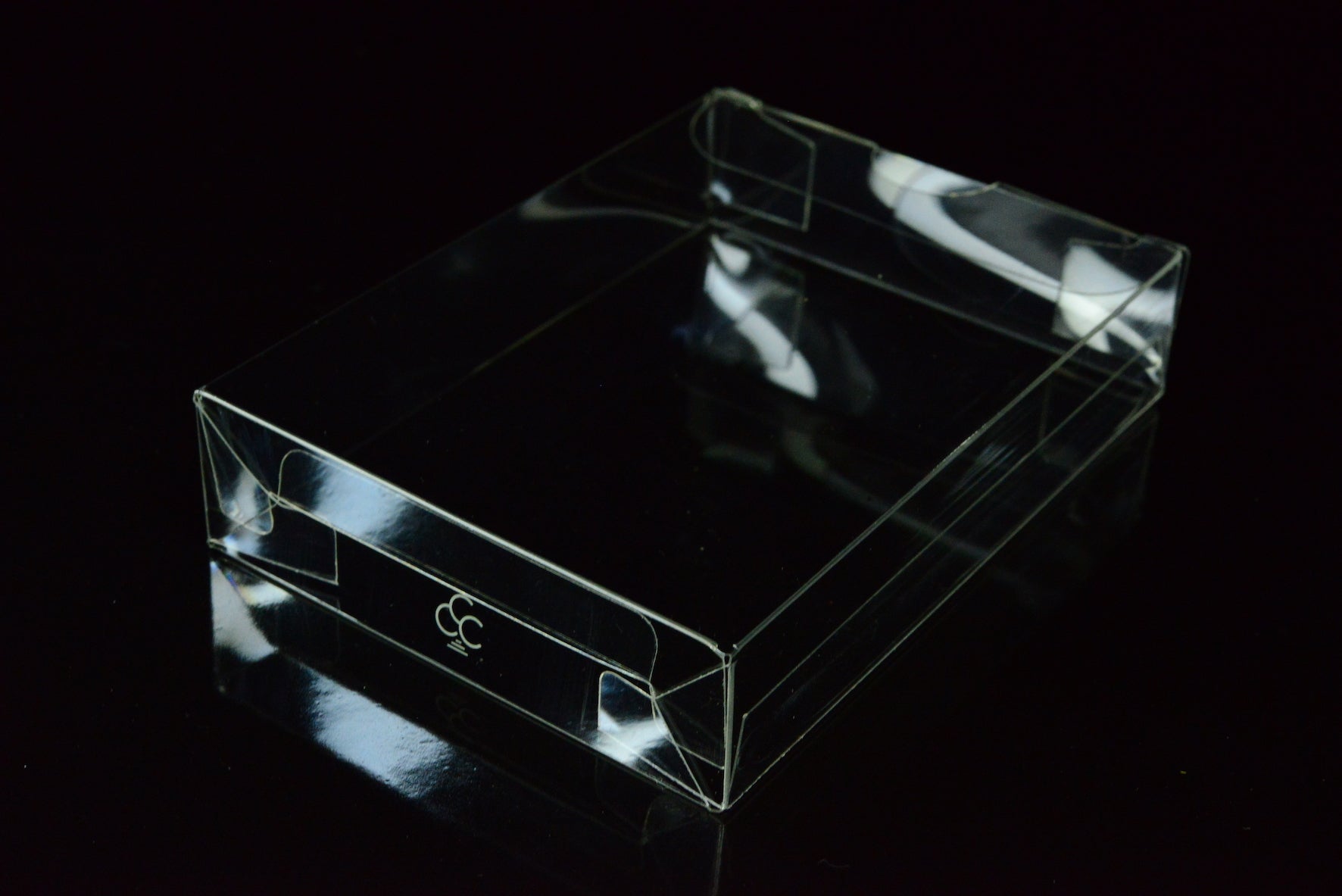 Clear plastic box with a logo on a black background
