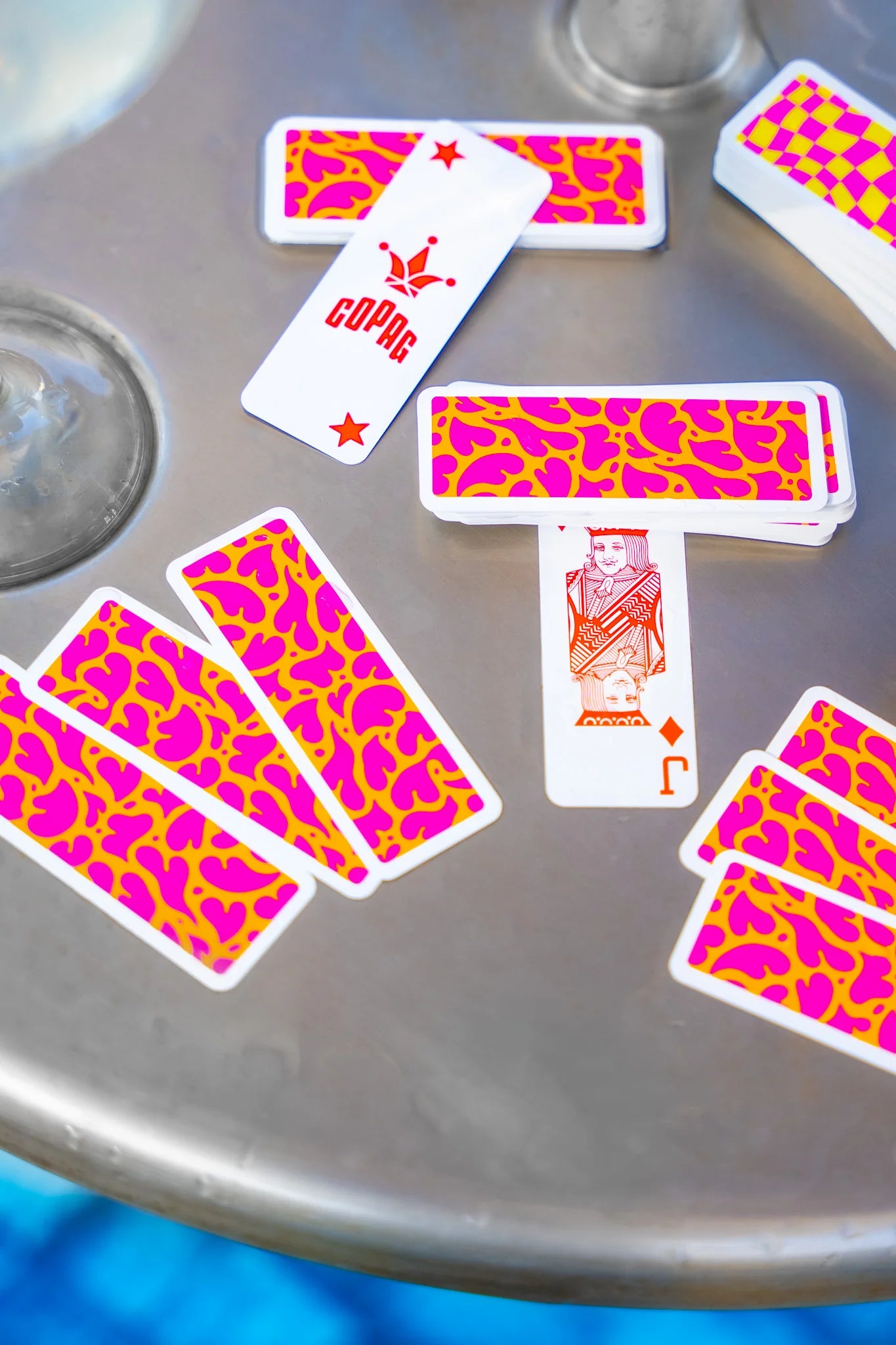 Copag Go Deck – Hearts Design Playing cards with pink and orange patterns on a metallic surface