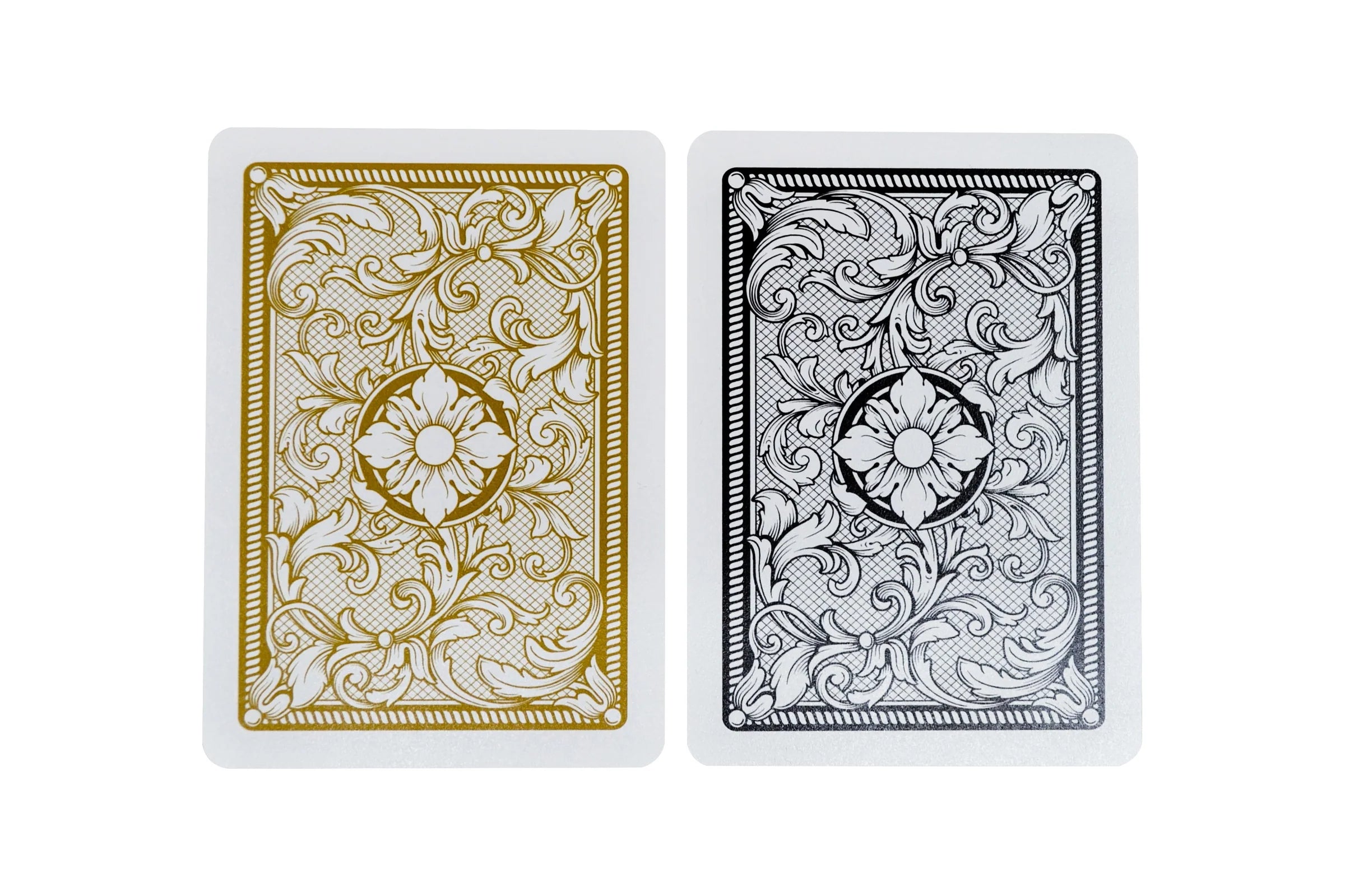 Two Copag Legacy Poker Size Jumbo Index (Black & Gold) playing cards with decorative designs on a white background