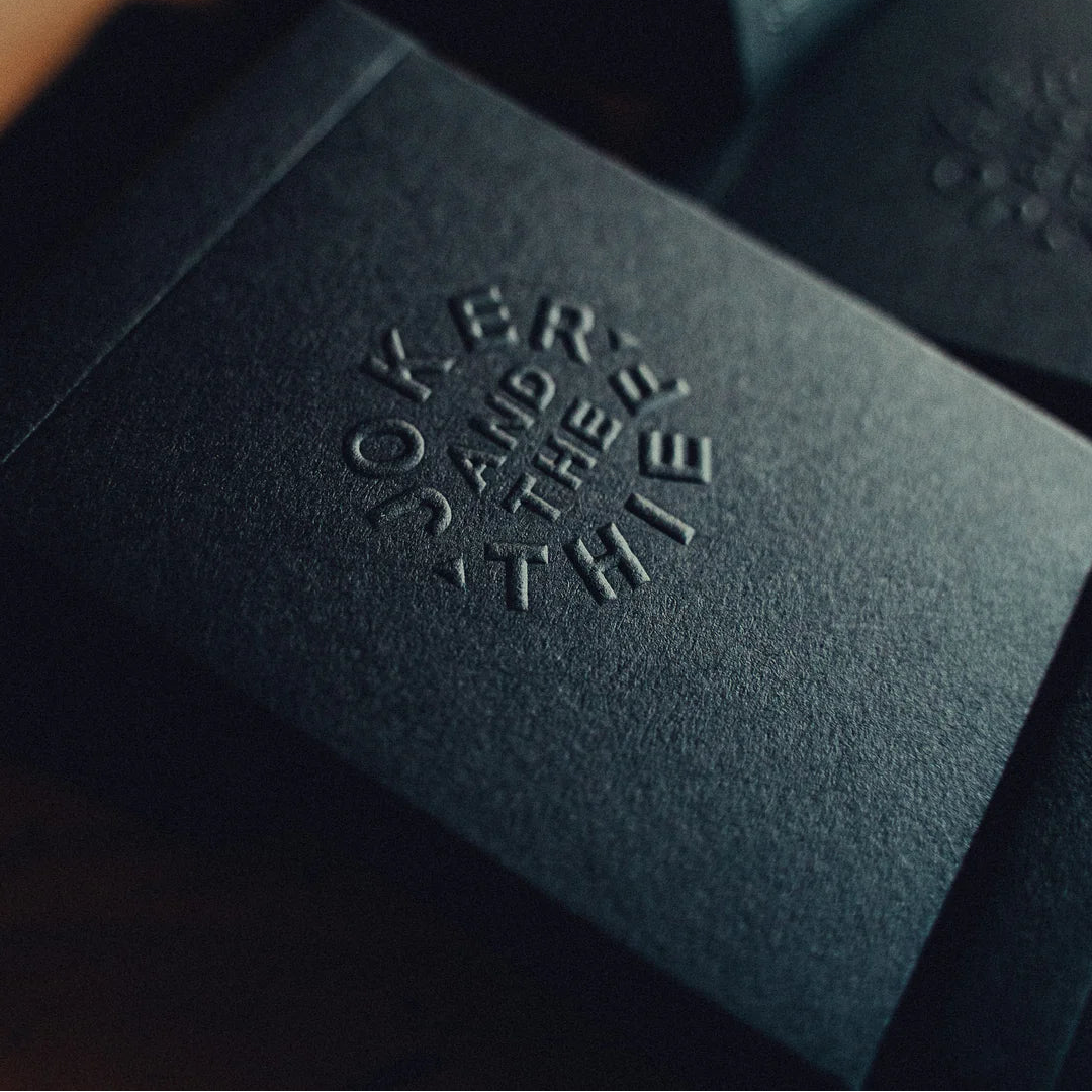Black leather deck with embossed text on a dark background