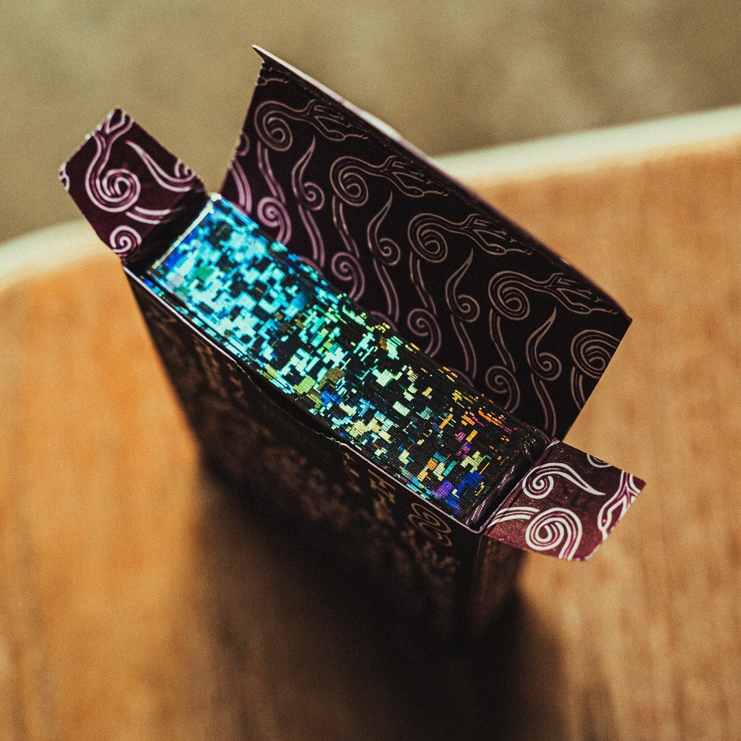 Decorative Crown: Royal Purple Edition box with glittery interior on a wooden surface