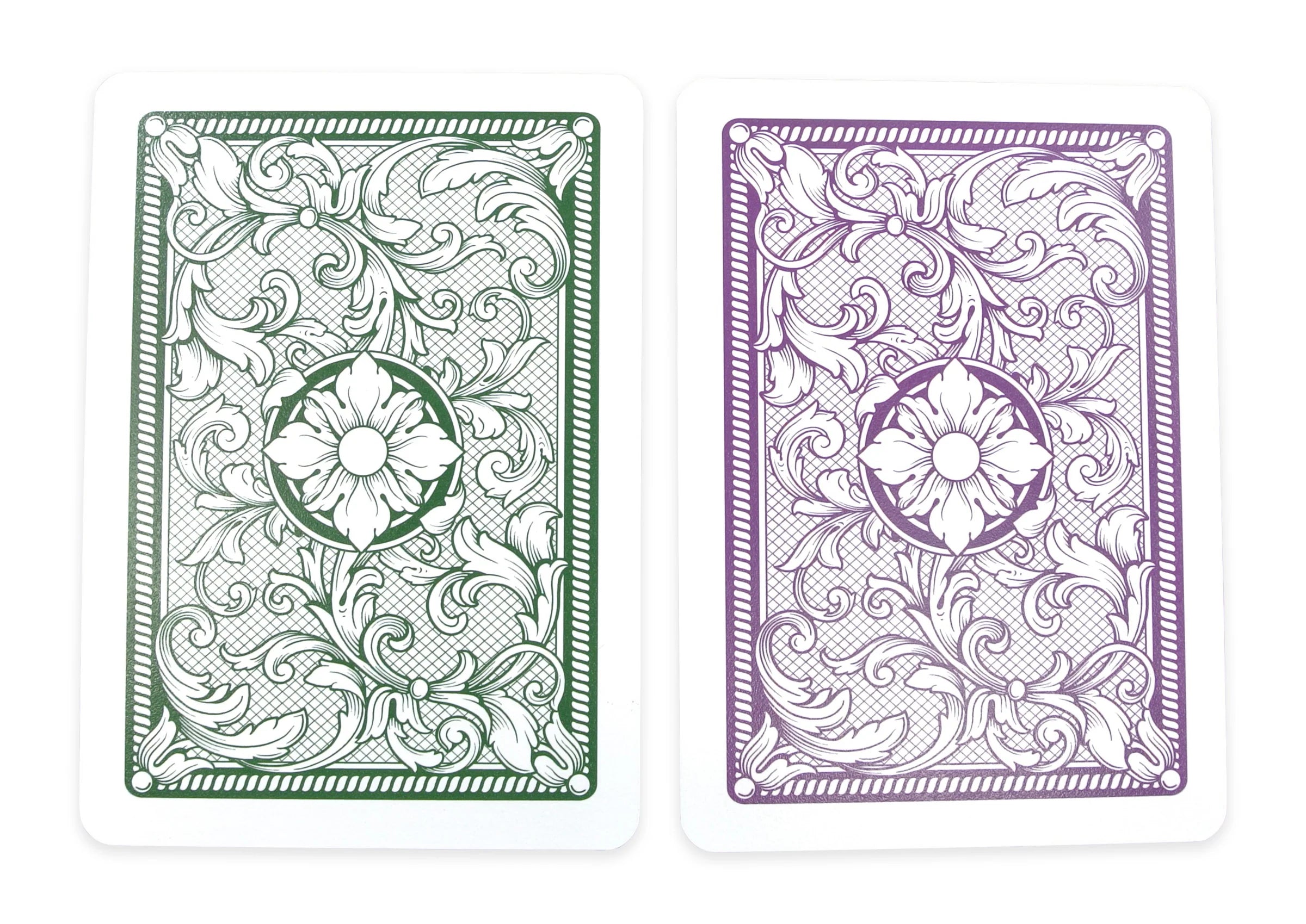 Two Copag Legacy Poker Size Jumbo Index (Green & Purple) playing cards with intricate designs, one green and one purple, on a white background.