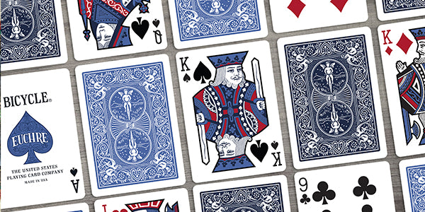 Collection of Euchre playing cards with visible branding and card suits.