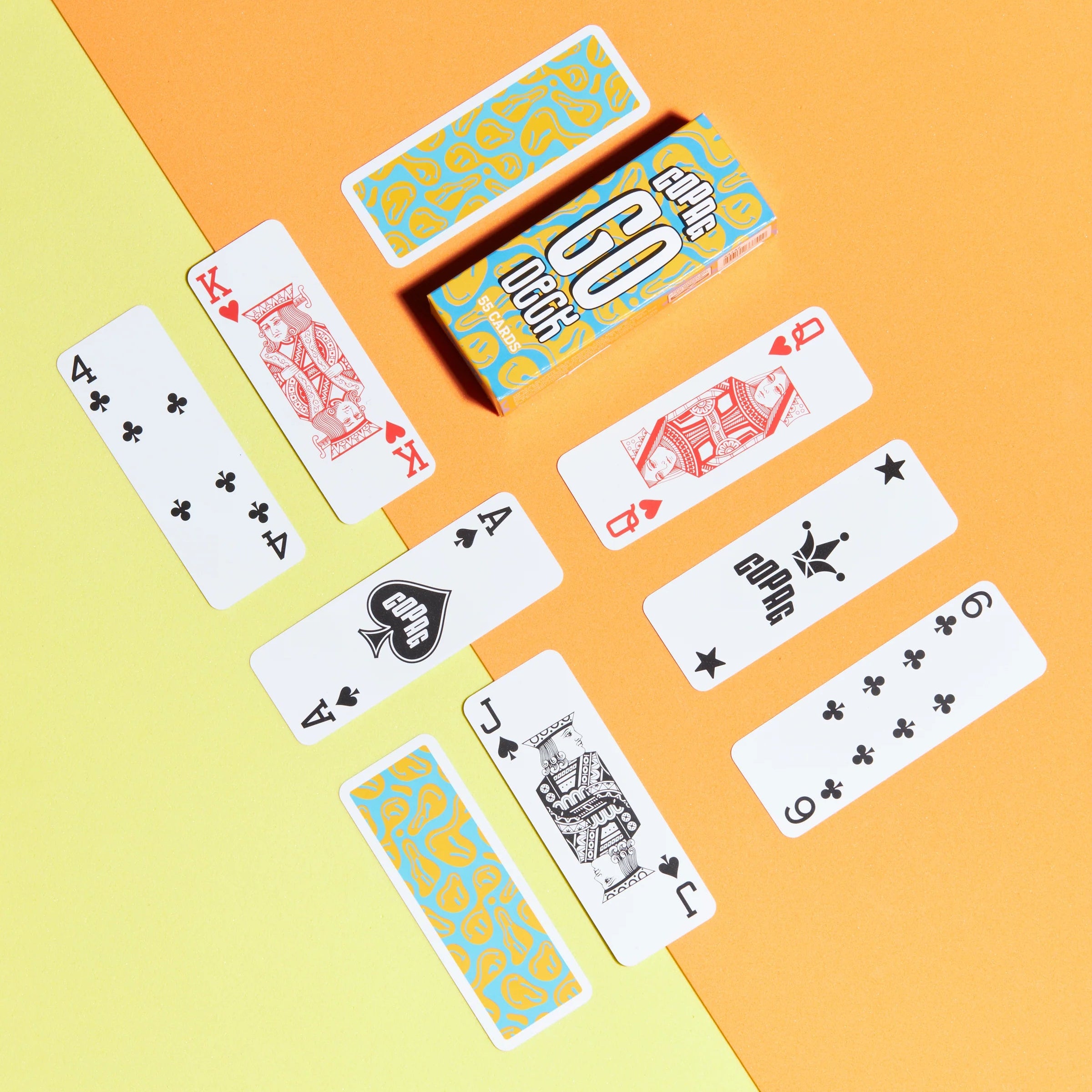 Copag Go Deck – Smiles Design Playing cards arranged on a yellow and orange background