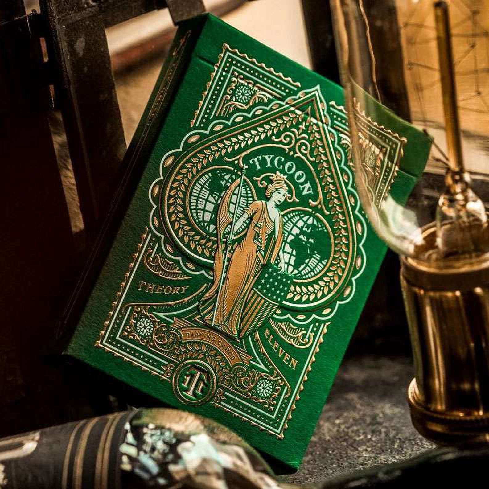 Green and gold playing card box with 'Tycoon' branding on a dark surface.
