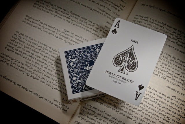 Playing cards with 'Hoyle Products' branding on an open book
