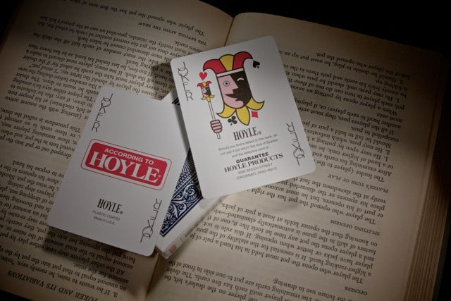 Playing cards with 'According to Hoyle' branding on an open book