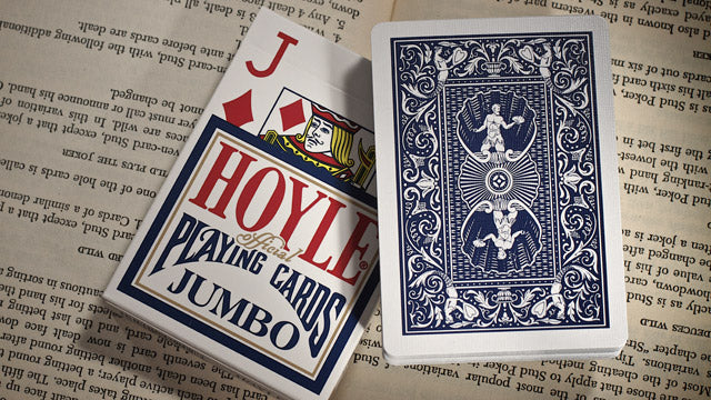 Hoyle playing cards with a blue and red design on an old book page background
