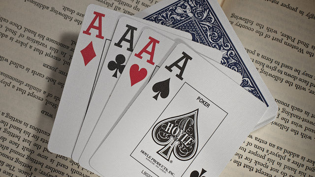 Four aces from a deck of playing cards on an old document background