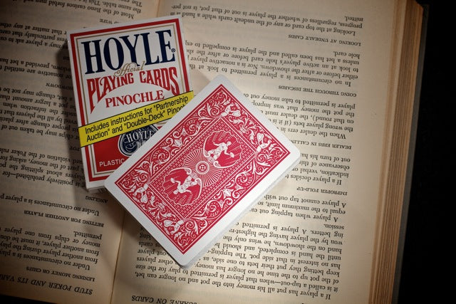 Hoyle playing cards on an open book