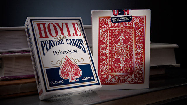 Two packs of Hoyle playing cards on a dark surface