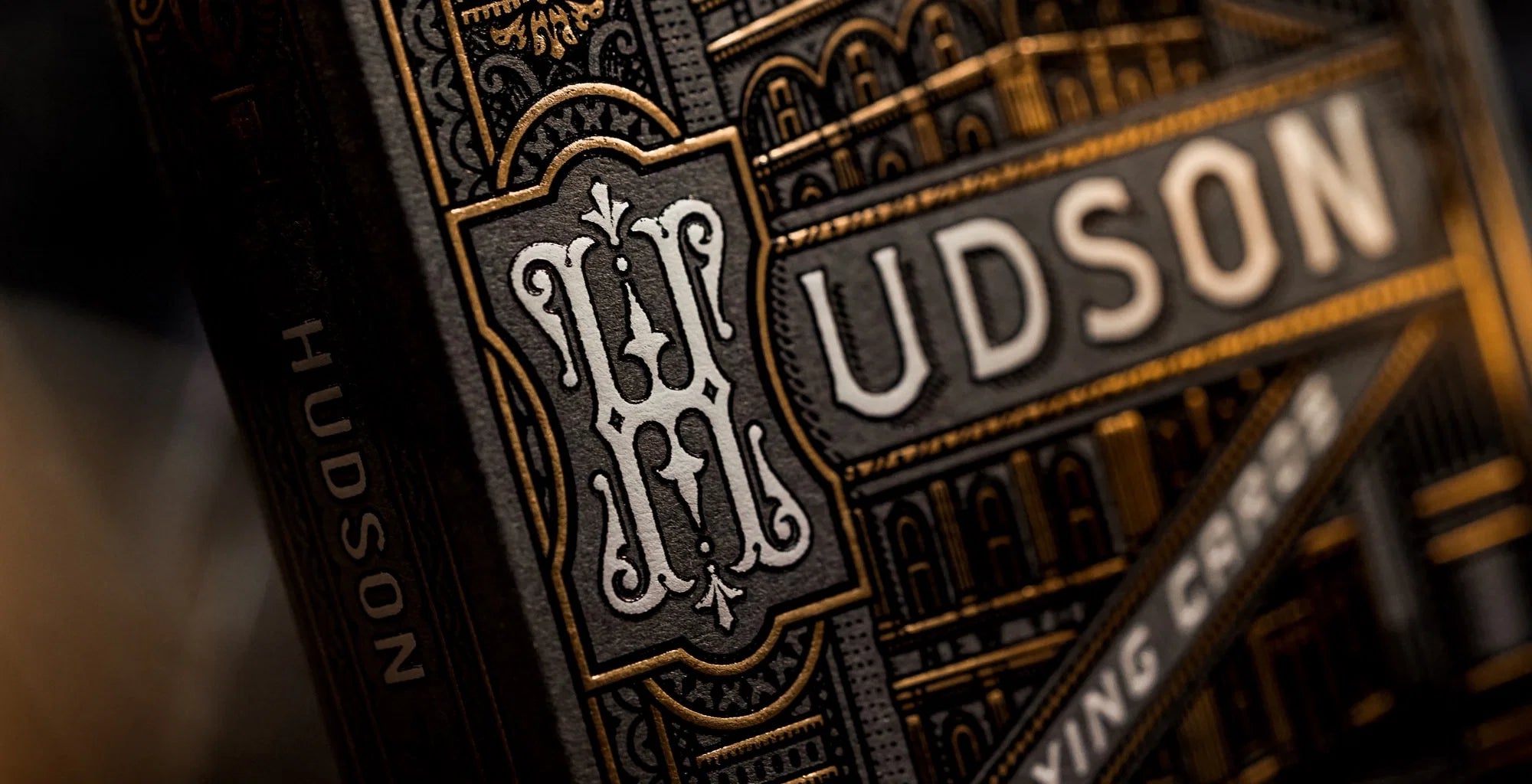 Close-up of the Theory11 Black Hudson tuck front and monogram detail