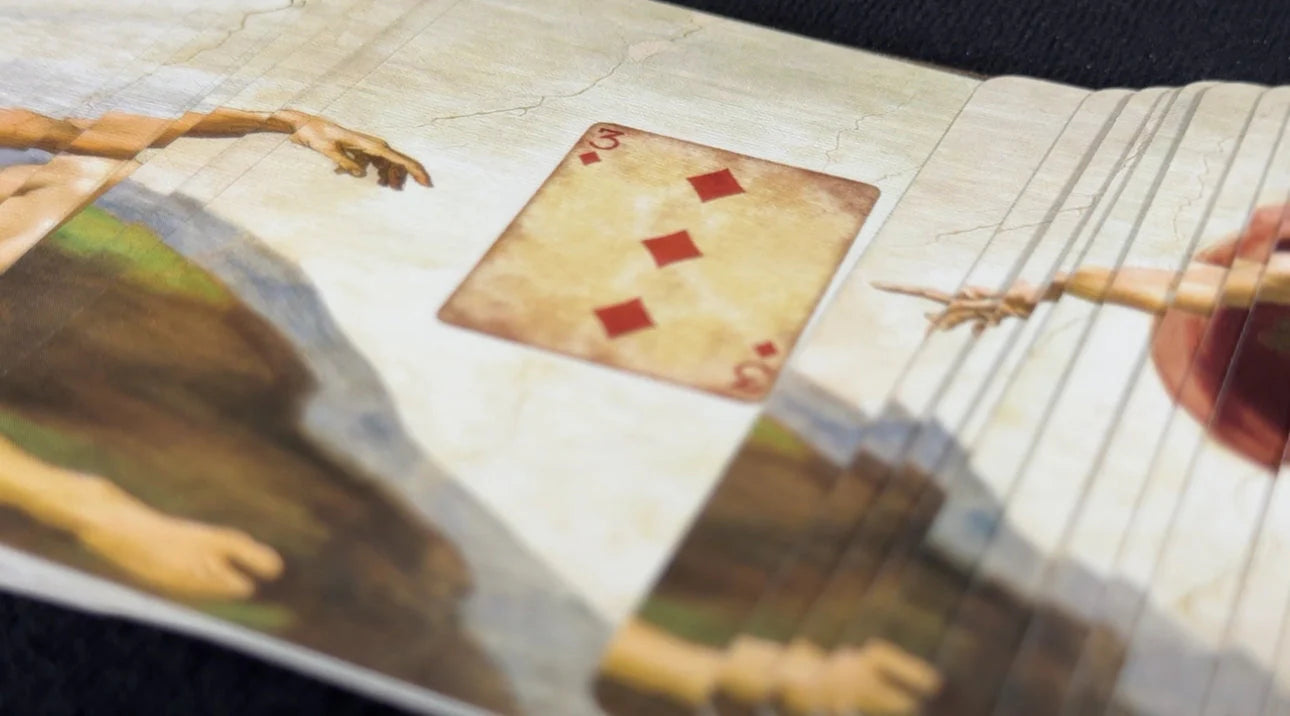 Close-up of a painting with a playing card superimposed over it