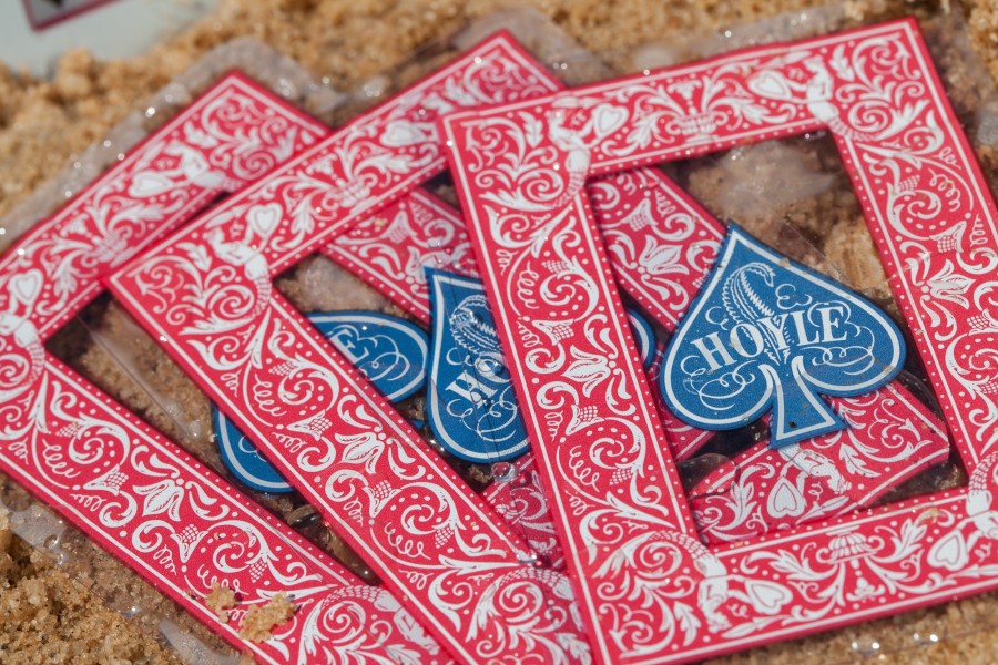 Playing cards with red and blue designs on a textured surface